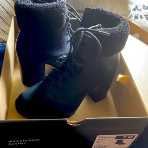 Black a.n.a leather booties with fur around the top.